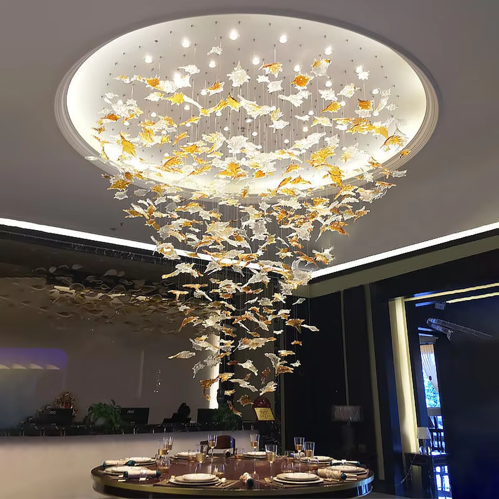 This large-scale art glass chandelier features a streamlined nebula/wave shape made of blue-white gradient transparent glass strips, hung in a suspended manner. It serves both lighting and artistic decorative purposes, ideal for high-ceiling commercial spaces such as hotel lobbies, high-end bars, and sales offices.