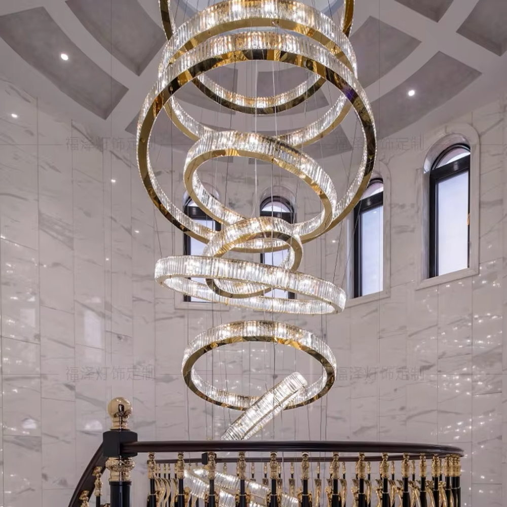 This light luxury spiral ring chandelier features a gold metal frame with embedded crystal/acrylic light strips, in a multi-layer scattered spiral shape, serving both lighting and decorative purposes, ideal for high-end high-ceiling spaces such as villa high-ceiling staircases, hotel lobbies, and sales offices.