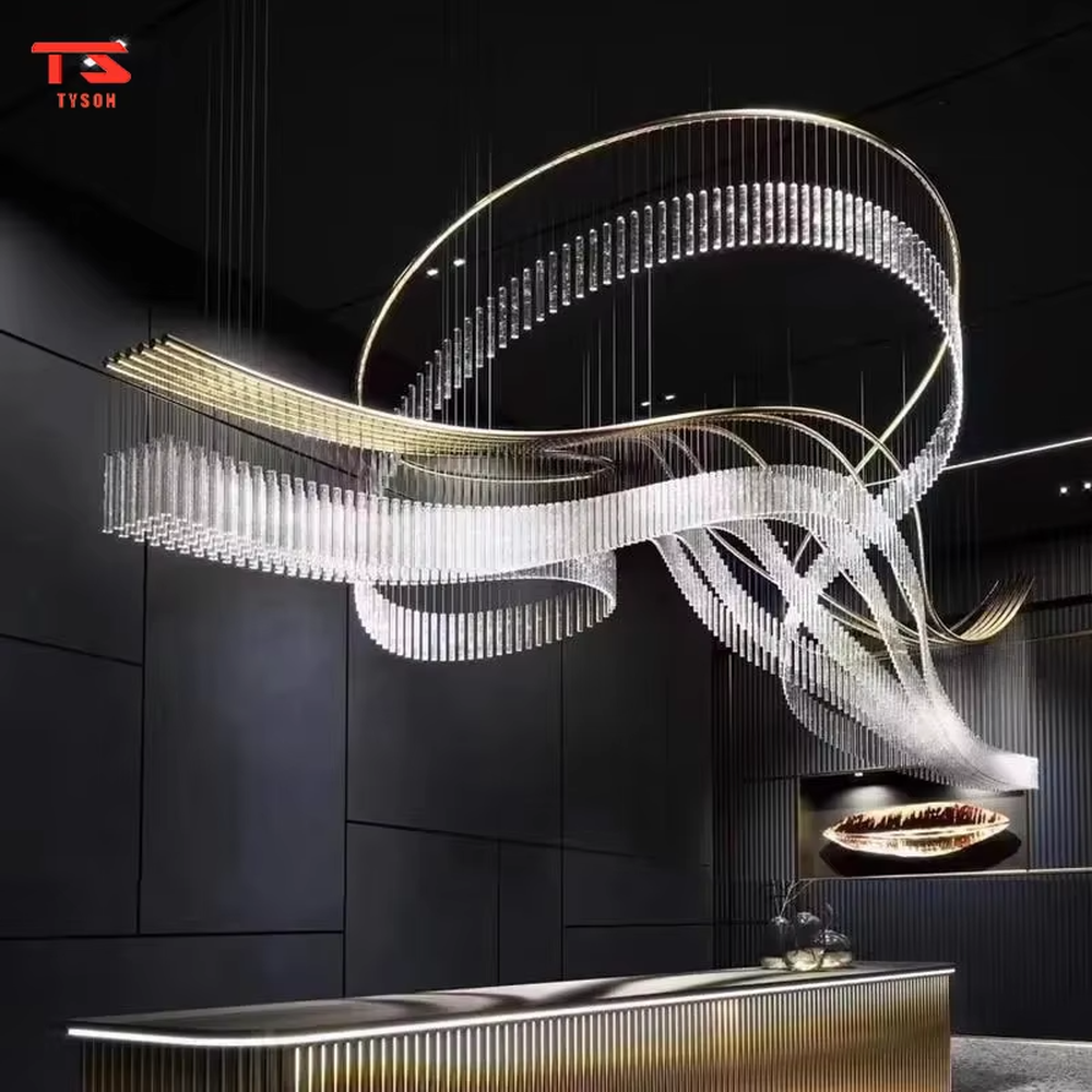 This large custom art chandelier features a gold metal frame paired with hanging crystal tassels to create a flowing ribbon shape, serving both lighting and artistic decoration purposes, ideal for high-ceiling commercial spaces such as high-end clubs, hotel lobbies, and sales offices.