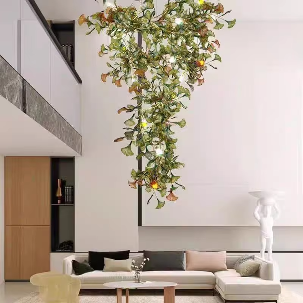 Art Ginkgo Leaf Light Luxury Chandelier (orange-yellow gradient glass leaves + gold metal frame), warm light effect, creating a natural and elegant atmosphere in large flat-floor living rooms.