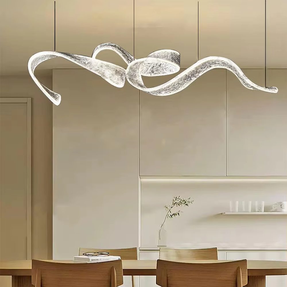 Art ribbon curve chandelier (transparent texture acrylic + flowing shape), warm light effect, creating a minimalist artistic space atmosphere.