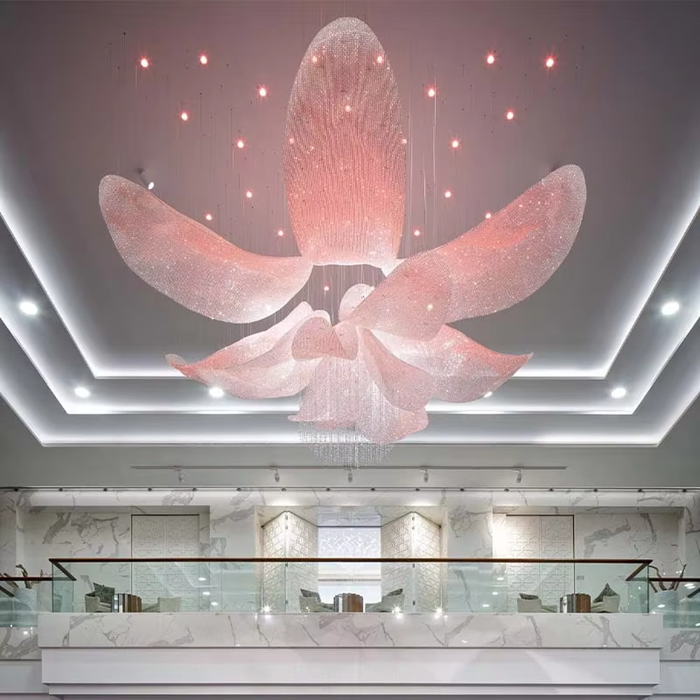 This large-scale art chandelier features a blooming flower shape, with petal structures made of translucent crystal/acrylic material, paired with gradient blue-purple lighting and starry sky accents. It serves both lighting and artistic decorative purposes, ideal for high-ceiling commercial spaces such as hotel lobbies, sales offices, and high-end clubs.