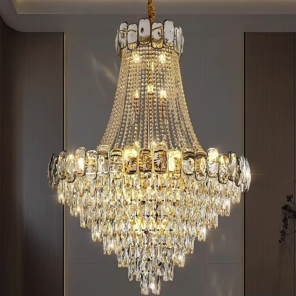 Luxurious golden double-layer crystal chandelier, upper and lower rectangular crystal decorations + crystal tassel shape, warm light presents brilliant light effect through crystals, creating a high-end luxurious space atmosphere.