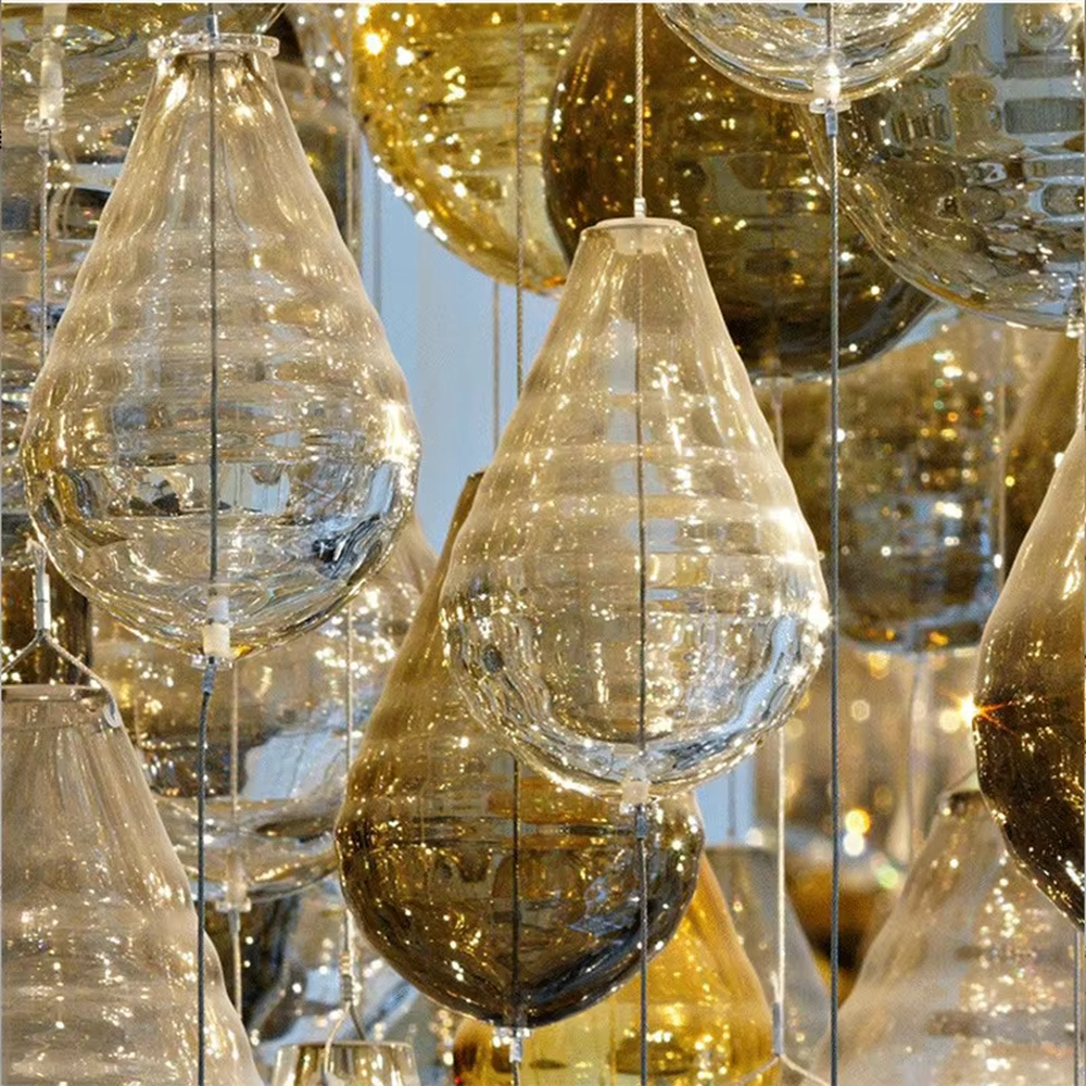 This large dome crystal chandelier features a multi-layered hanging teardrop design made of transparent and yellow-white gradient crystals, serving both lighting and artistic decoration purposes, with free design and professional engineering customization available, ideal for high-end high-ceiling spaces such as villa staircases, hotel lobbies, and sales offices.