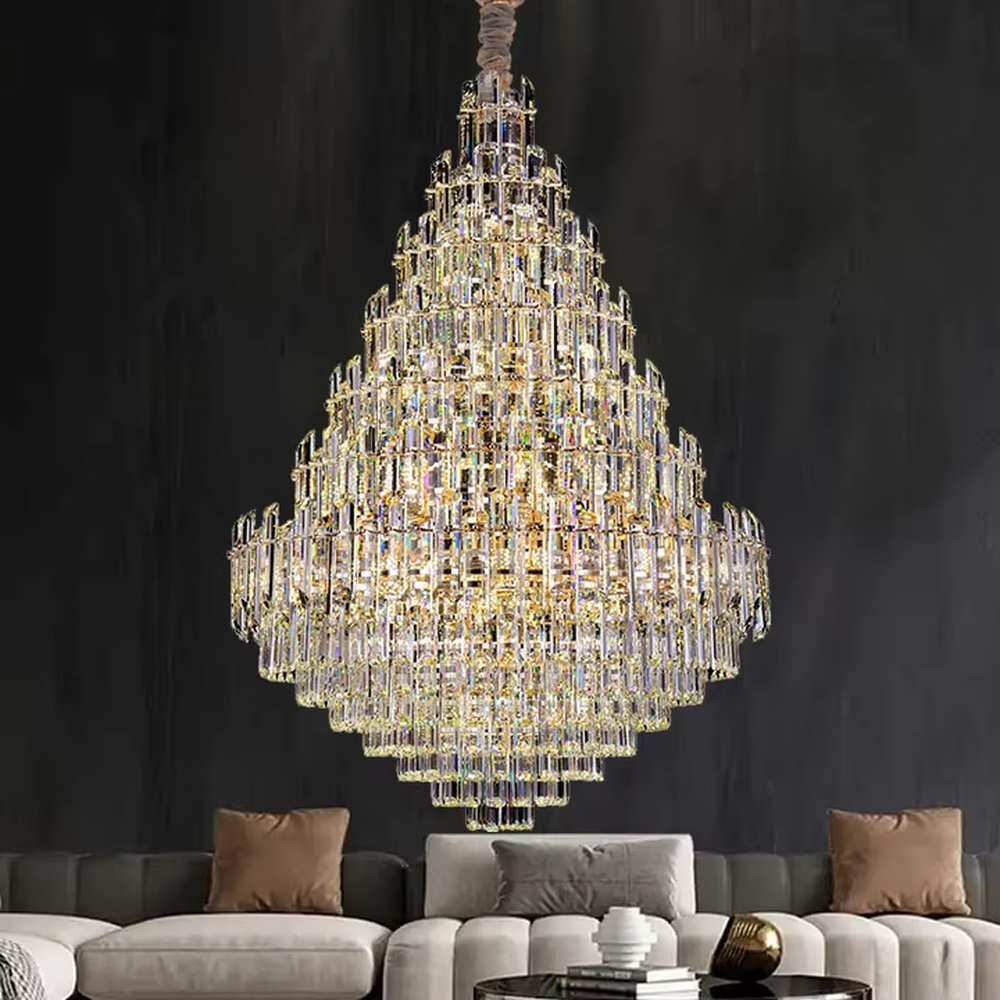 European top-luxury pyramid-shaped golden frame long crystal chandelier, warm light effect, creating a luxurious and magnificent space atmosphere.