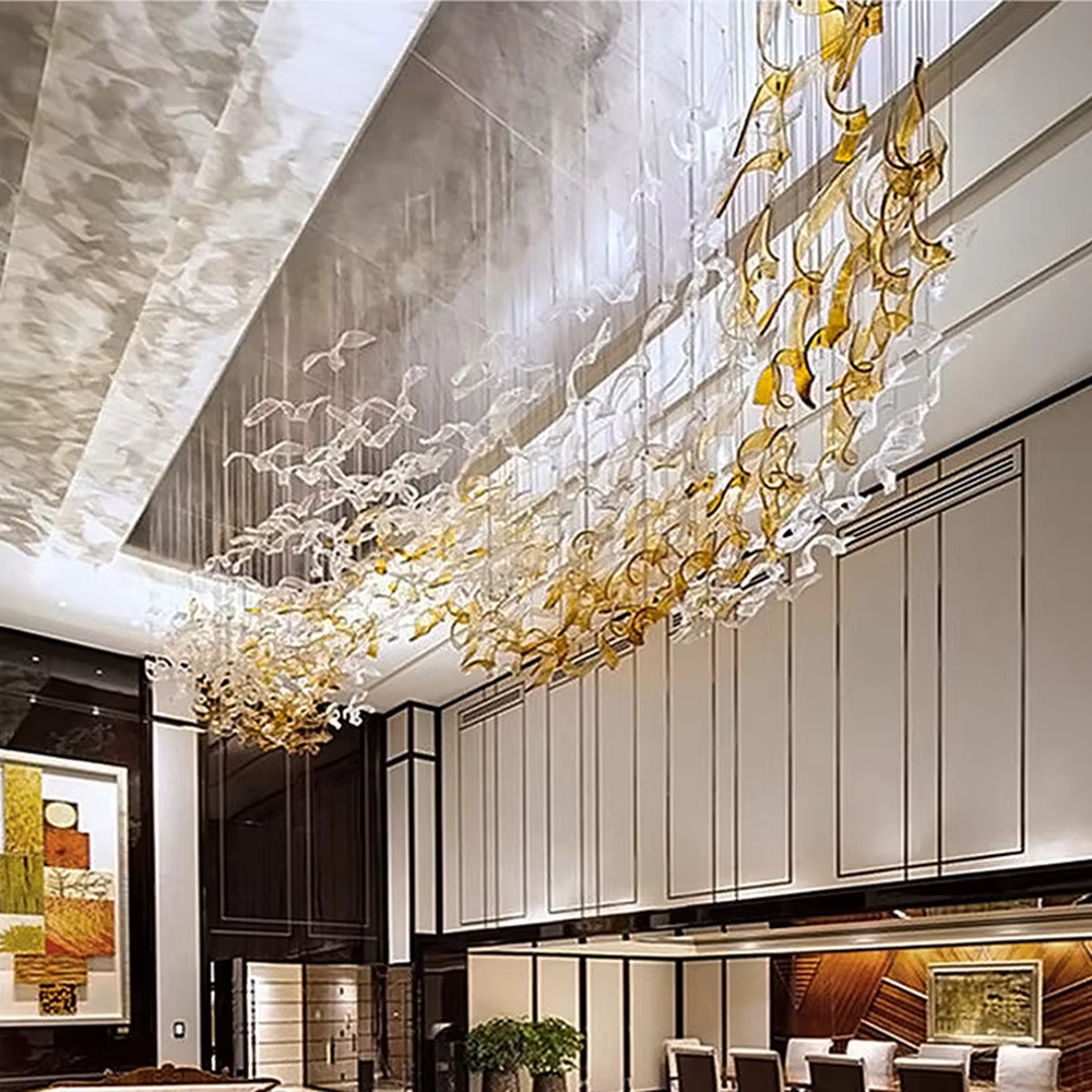 This large-scale art glass chandelier features a streamlined nebula/wave shape made of blue-white gradient transparent glass strips, hung in a suspended manner. It serves both lighting and artistic decorative purposes, ideal for high-ceiling commercial spaces such as hotel lobbies, high-end bars, and sales offices.