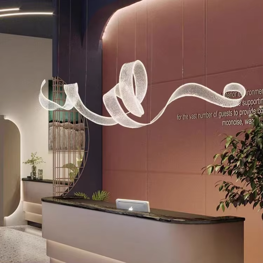 Art ribbon curve chandelier (transparent texture acrylic + flowing shape), warm light effect, creating a minimalist artistic space atmosphere.