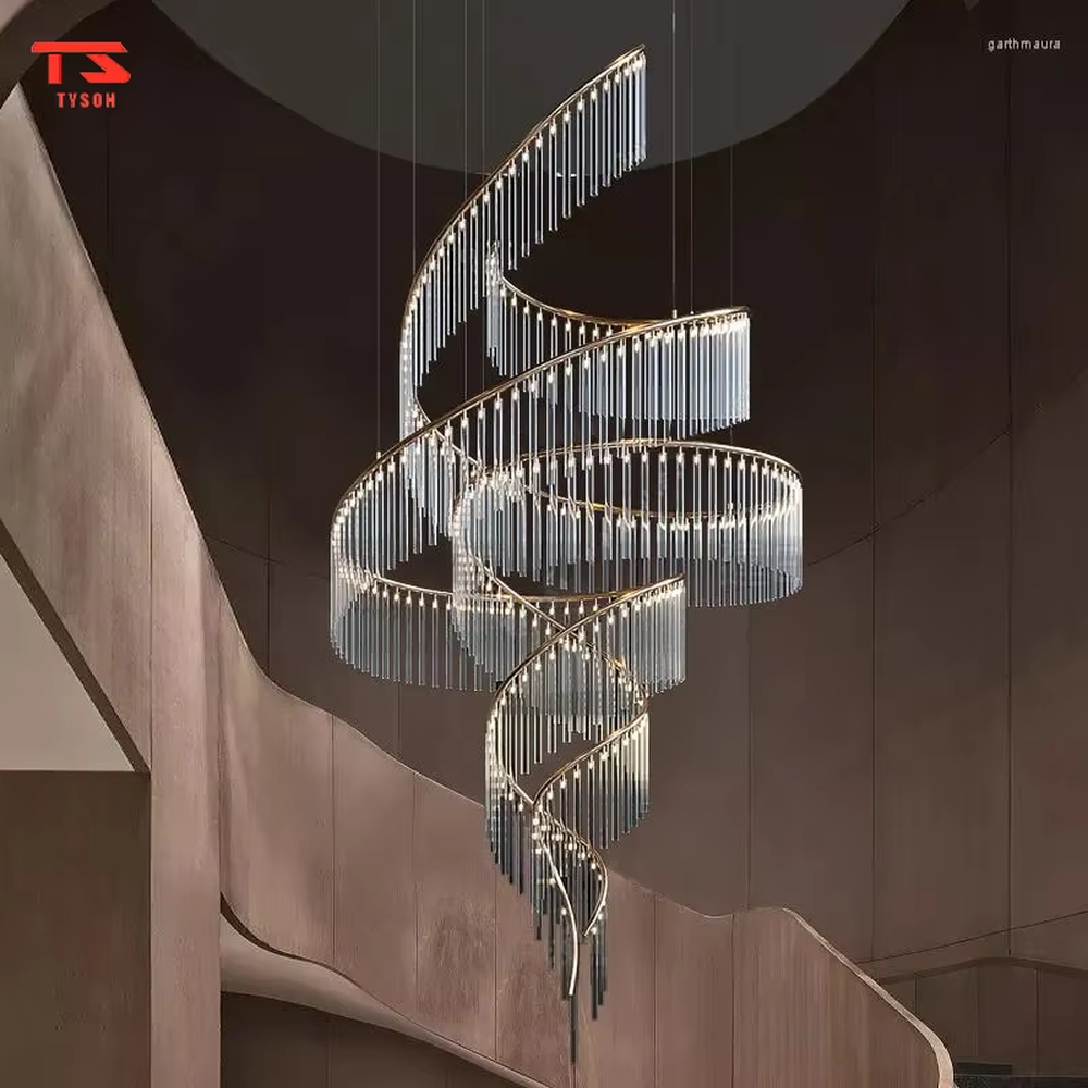 This large custom art chandelier features a gold metal frame paired with hanging crystal tassels to create a flowing ribbon shape, serving both lighting and artistic decoration purposes, ideal for high-ceiling commercial spaces such as high-end clubs, hotel lobbies, and sales offices.