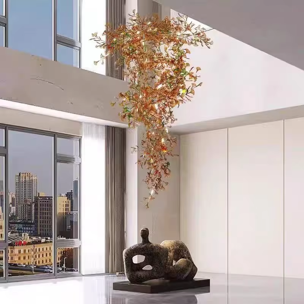 Art Ginkgo Leaf Light Luxury Chandelier (orange-yellow gradient glass leaves + gold metal frame), warm light effect, creating a natural and elegant atmosphere in large flat-floor living rooms.