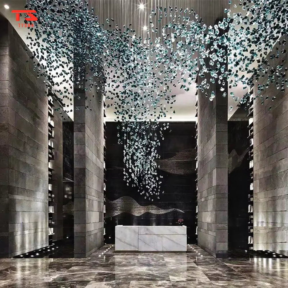 This large custom art crystal chandelier features a suspended green plant/wave shape made of green-white gradient crystal clusters, hung with slender suspension rods, serving both lighting and artistic decoration purposes, ideal for high-ceiling commercial spaces such as sales offices, hotel lobbies, and high-end clubs.