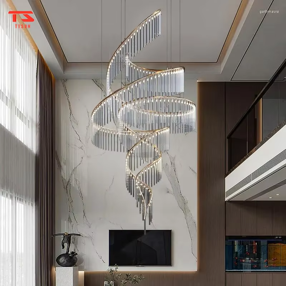 This large custom art chandelier features a gold metal frame paired with hanging crystal tassels to create a flowing ribbon shape, serving both lighting and artistic decoration purposes, ideal for high-ceiling commercial spaces such as high-end clubs, hotel lobbies, and sales offices.