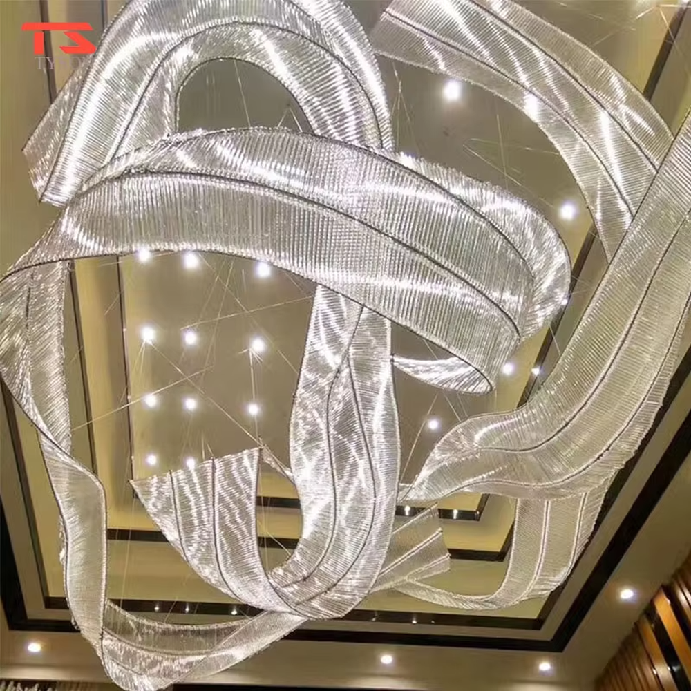 This large-scale art ribbon chandelier is made of semi-translucent material with pink-purple-blue-green gradients, featuring a flowing, pendant ribbon shape. It serves both lighting and artistic installation purposes, ideal for high-ceiling commercial spaces such as shopping mall atriums, hotel lobbies, and art galleries.
