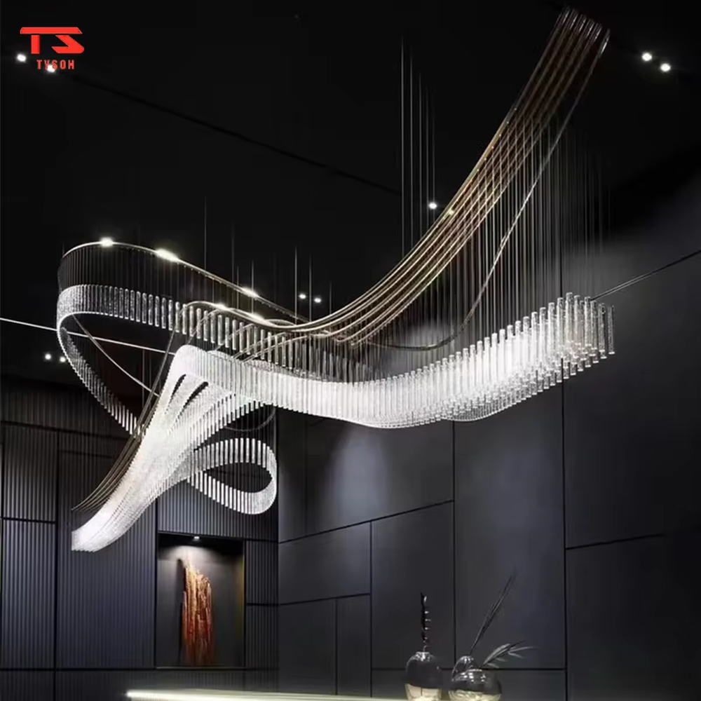 This large custom art chandelier features a gold metal frame paired with hanging crystal tassels to create a flowing ribbon shape, serving both lighting and artistic decoration purposes, ideal for high-ceiling commercial spaces such as high-end clubs, hotel lobbies, and sales offices.