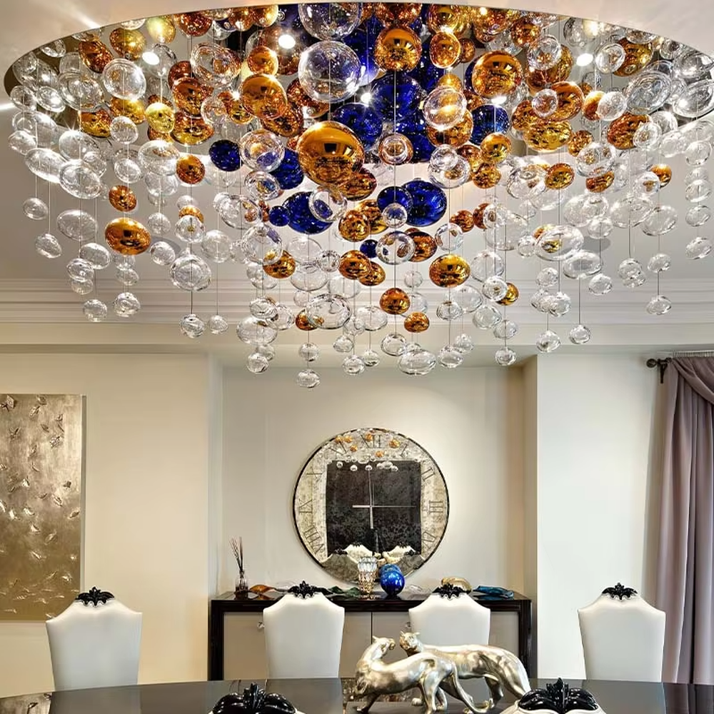 Art colorful glass ball suspension chandelier (gold/blue/transparent combination), warm light effect, creating a dreamy and brilliant luxurious space atmosphere.