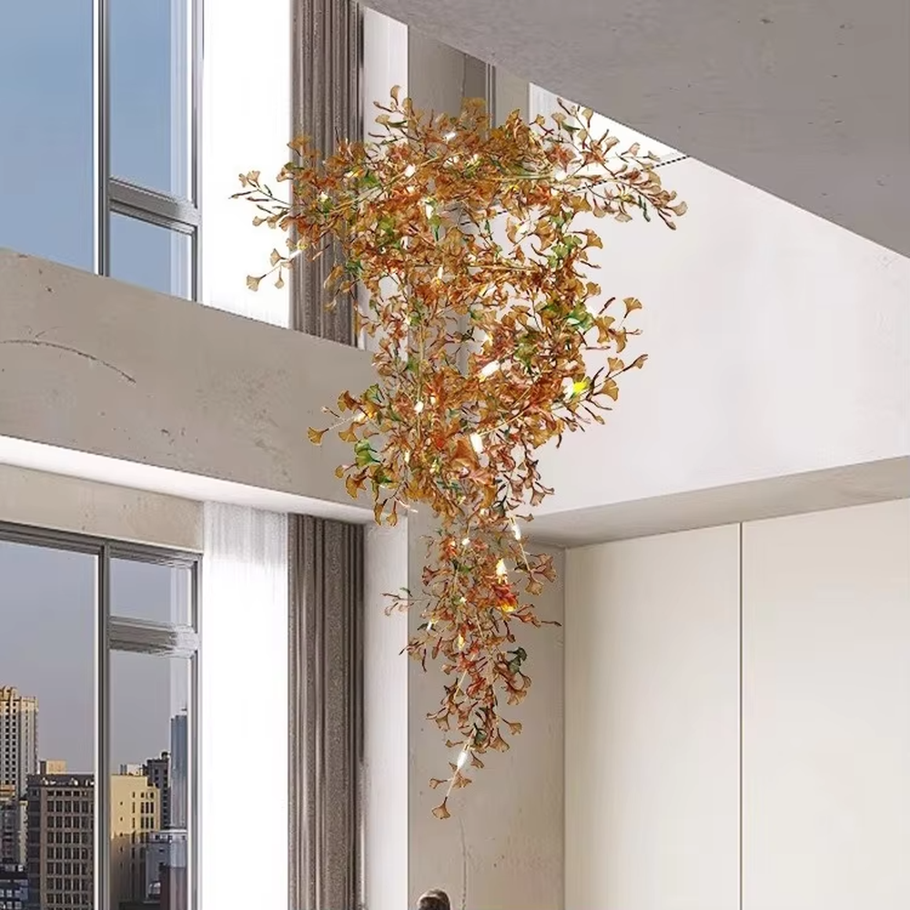 Art Ginkgo Leaf Light Luxury Chandelier (orange-yellow gradient glass leaves + gold metal frame), warm light effect, creating a natural and elegant atmosphere in large flat-floor living rooms.