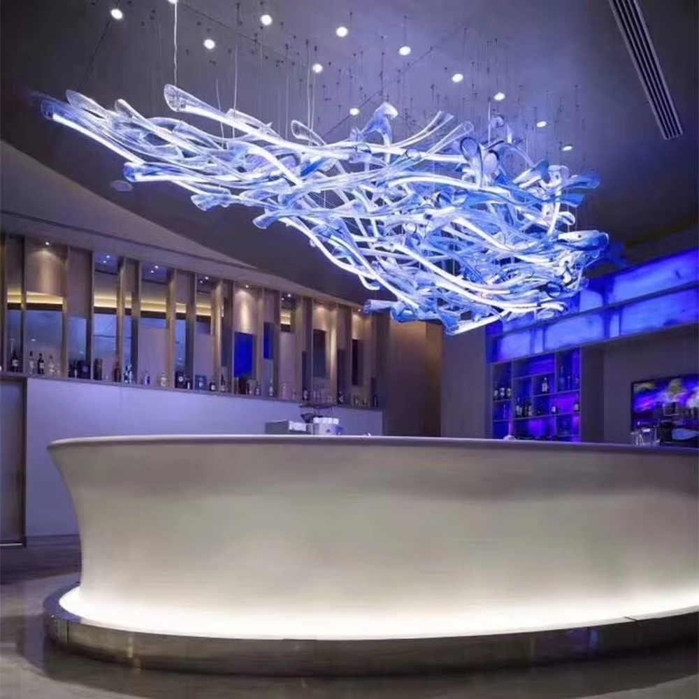 This large-scale art glass chandelier features a streamlined nebula/wave shape made of blue-white gradient transparent glass strips, hung in a suspended manner. It serves both lighting and artistic decorative purposes, ideal for high-ceiling commercial spaces such as hotel lobbies, high-end bars, and sales offices.