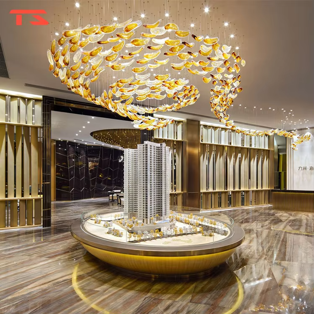This large custom art glass chandelier features a streamlined school-of-fish/cloud-belt shape made of yellow-white gradient glass leaves, suspended in a floating manner, serving both lighting and artistic decoration purposes, ideal for high-ceiling commercial spaces such as sales offices, hotel lobbies, and high-end clubs.