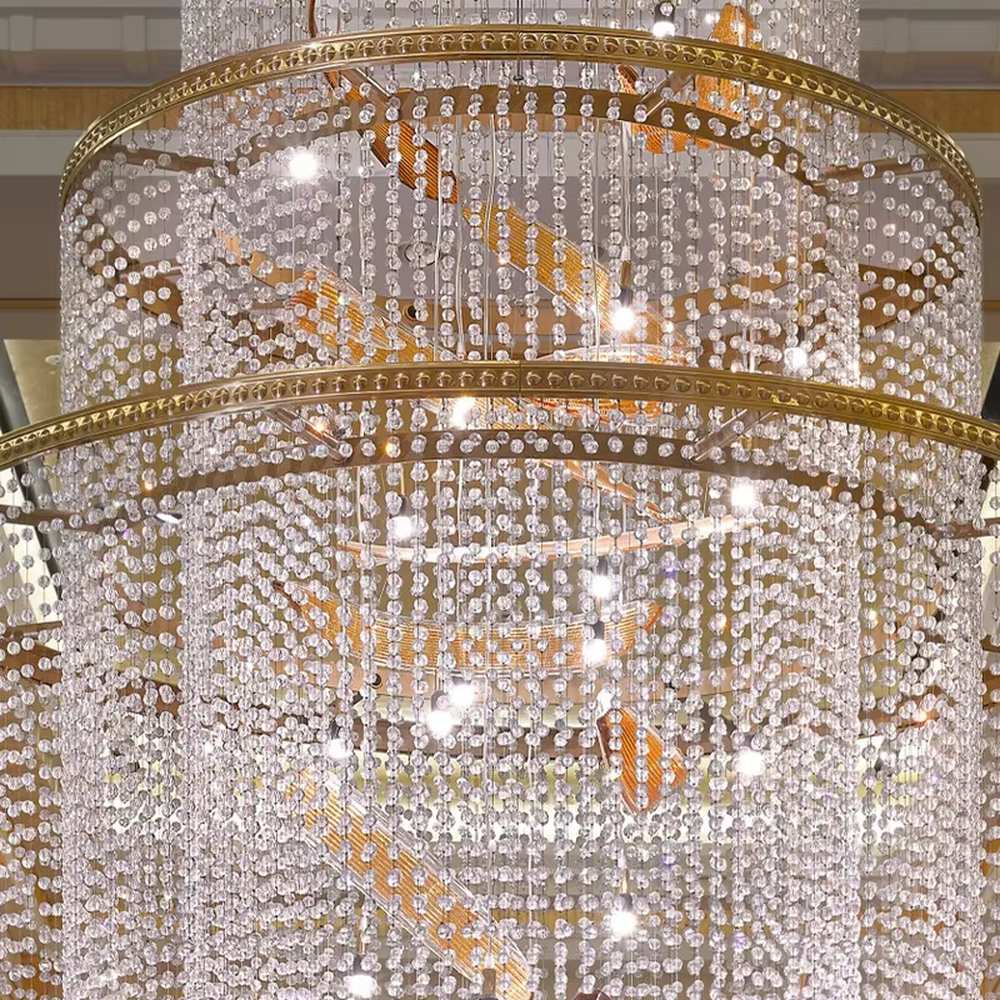 Luxury multi-layer crystal chandelier (spiral gold accessories + full-set crystals), warm light effect, creating a luxurious and elegant high-end space atmosphere.