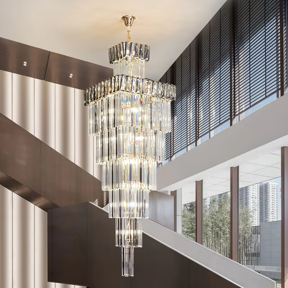 Modern light luxury multi-layer square tower-shaped golden frame crystal chandelier, warm light effect, creating an exquisite and luxurious modern space atmosphere.