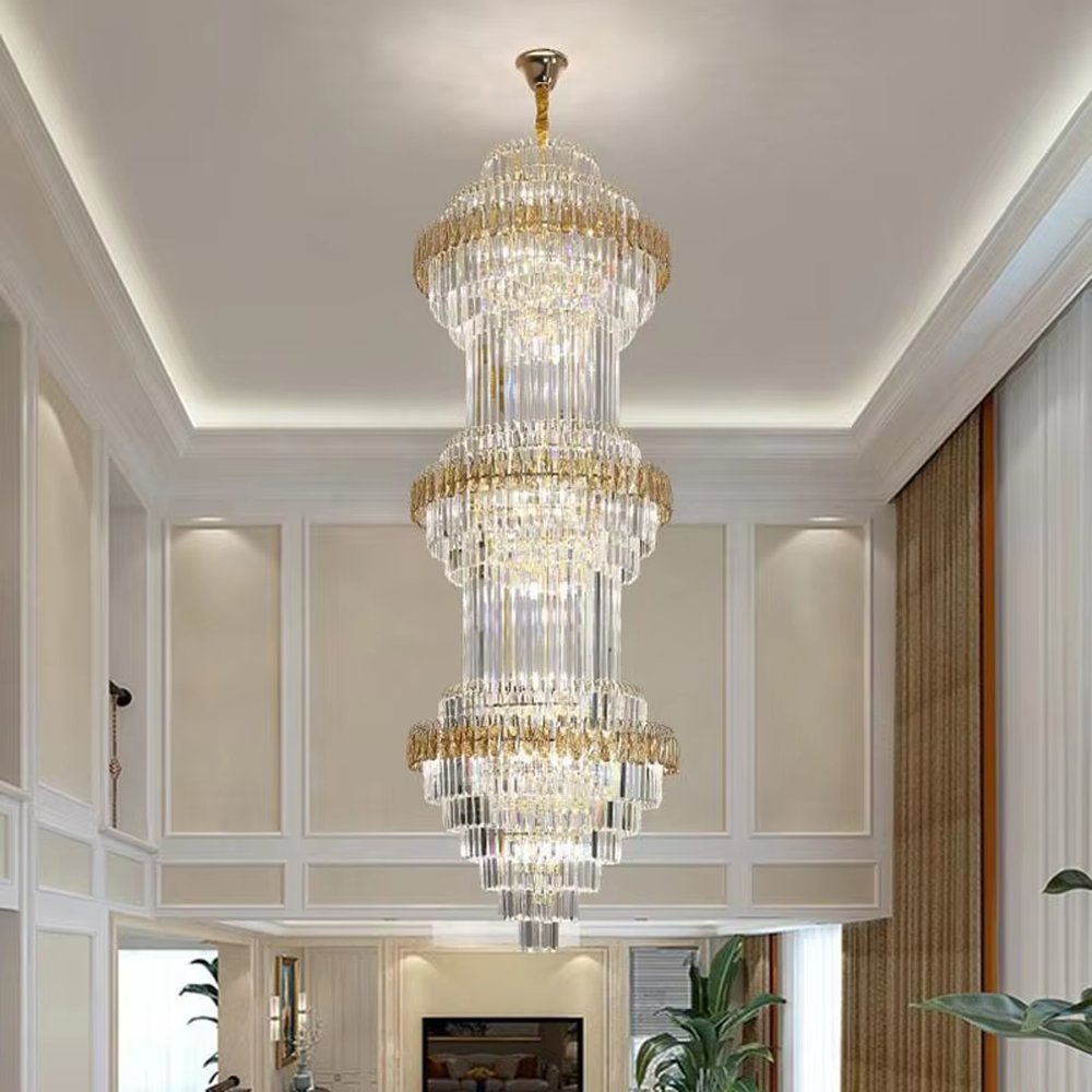 Modern top-luxury multi-layer crystal tower-shaped high-ceiling chandelier (gold-gray frame + long crystals), warm light effect, creating a luxurious and grand space atmosphere.