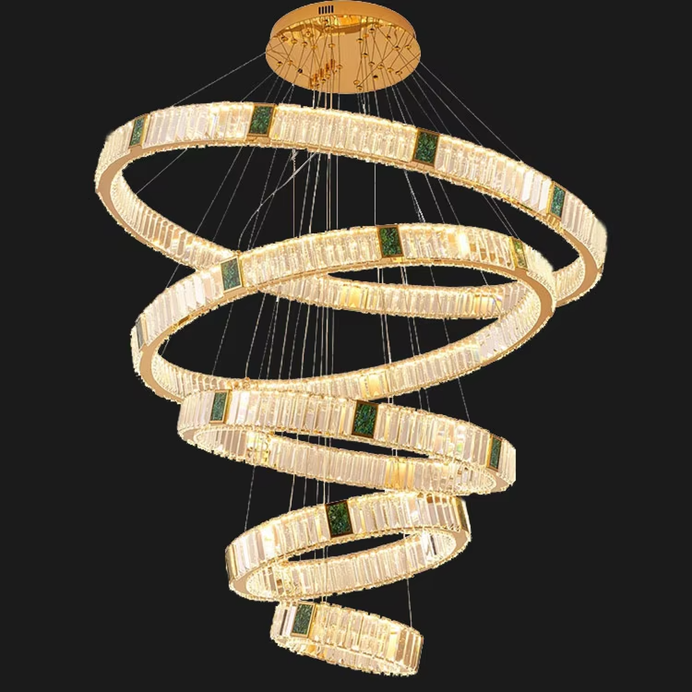This is a light luxury artistic spiral crystal chandelier, featuring multi-layered circular crystal strips paired with a gold metal frame and emerald accents, shaped like a flowing tornado. Light refracts through the crystals to create brilliant and luxurious lighting effects, serving both lighting and artistic decoration purposes, suitable for high-ceiling spaces such as villa high-ceiling living rooms, duplex voids, hotel lobbies, and high-end clubs.