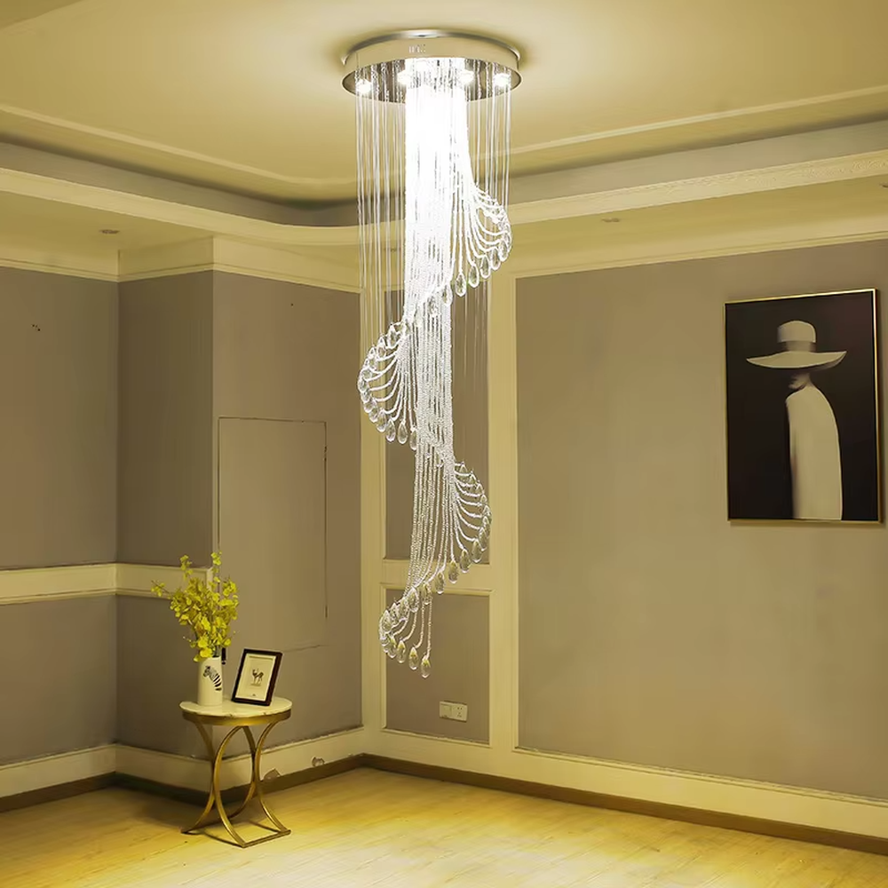 This is a modern light luxury style artistic crystal chandelier, composed of multiple layers of transparent crystal strings and teardrop-shaped crystal pendants. Its streamlined shape resembles a flowing waterfall of light, serving both lighting and artistic decoration purposes, suitable for high-ceiling spaces such as villa high-ceiling living rooms, duplex voids, hotel lobbies, and high-end clubs.