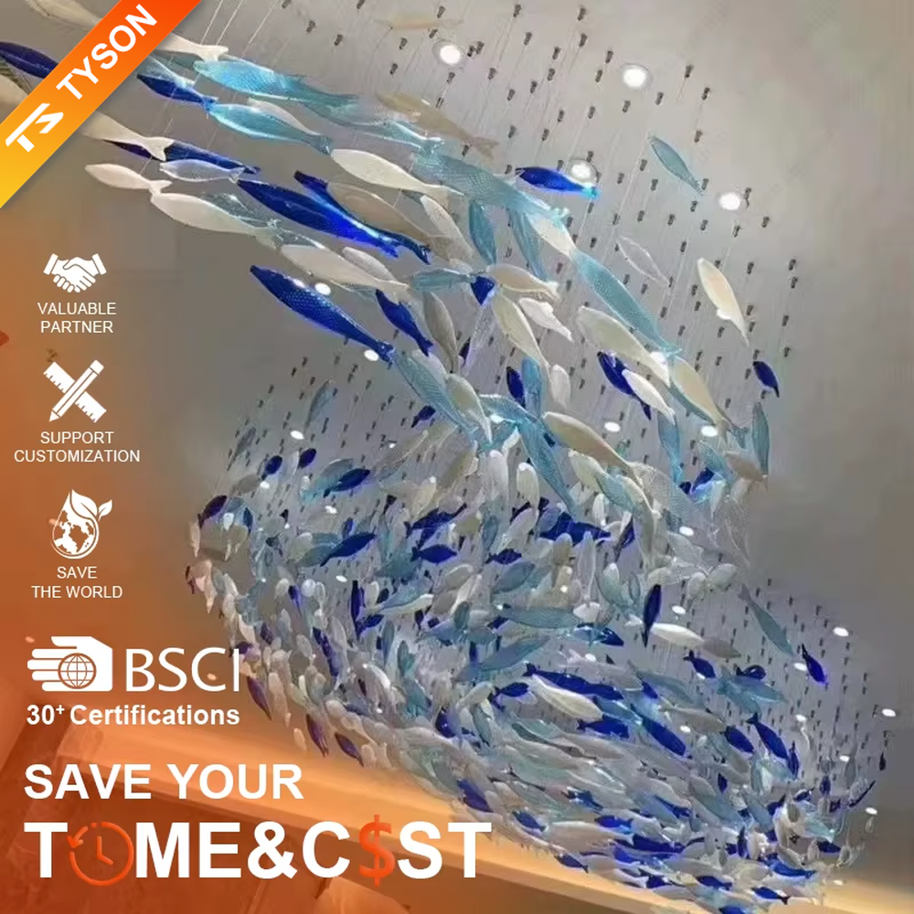 Art fish school-shaped chandelier (blue-white gradient glass fish + warm light), warm light effect, creating a dynamic and natural atmosphere for high-end public spaces.