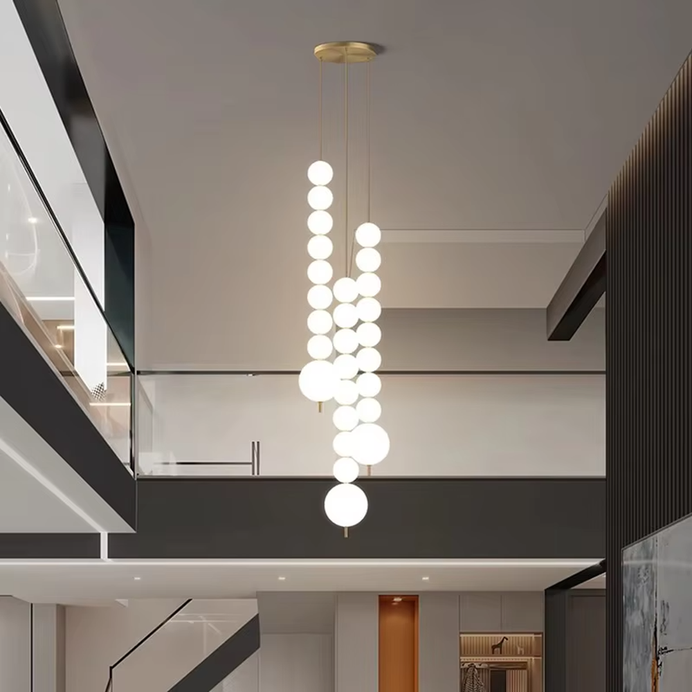Modern light luxury double-strip spherical cascading chandelier, with a gold metal top plate paired with two strips of milky white luminous bulbs hanging staggered, emitting soft and even light, combining decorativeness and practicality, suitable for core lighting and atmosphere creation in spaces such as dining rooms, high-ceiling living rooms, and duplex stairs.