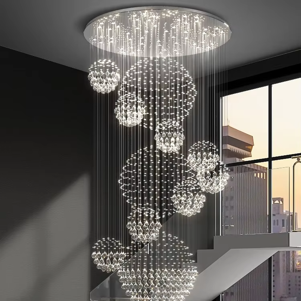 Modern luxury crystal ball cluster cascading chandelier, with a circular metal top plate paired with multiple groups of crystal-strung ball clusters hanging staggered, emitting brilliant and dreamy light, combining artistic decorativeness and lighting function, suitable for core decoration and main lighting in high-ceiling spaces such as duplex stairs, villa hollow areas, and high-end clubs.