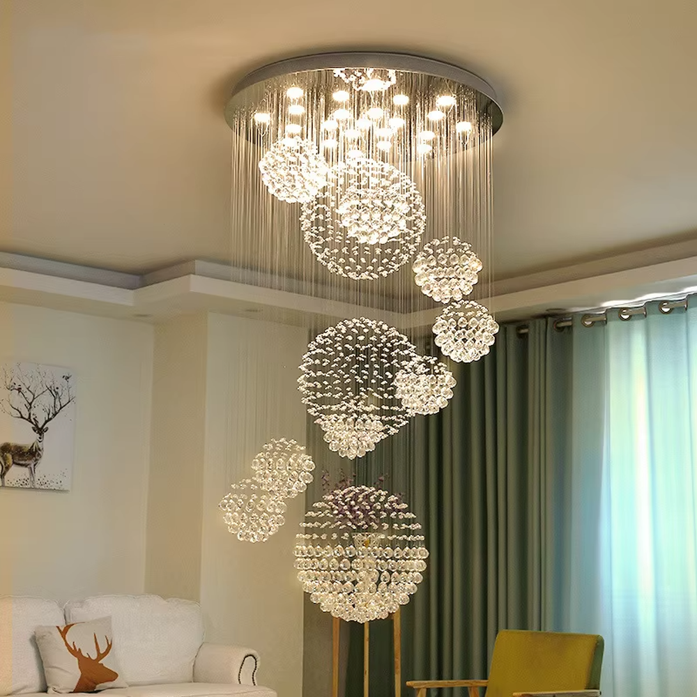 Modern luxury crystal ball cluster cascading chandelier, with a circular metal top plate paired with multiple groups of crystal-strung ball clusters hanging staggered, emitting brilliant and dreamy light, combining artistic decorativeness and lighting function, suitable for core decoration and main lighting in high-ceiling spaces such as duplex stairs, villa hollow areas, and high-end clubs.
