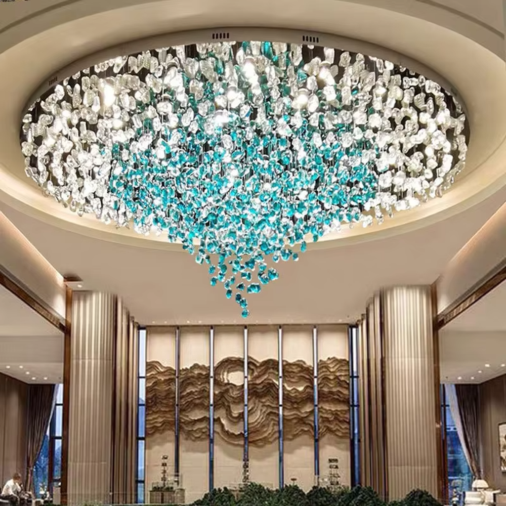 Gradient blue and white art engineering chandelier, crafted from transparent and turquoise crystal fragments to create a water-drop gradient shape, with transparent and brilliant light, designed to create a high-end artistic space atmosphere, suitable for large high-end scenarios such as hotel lobbies, sales office reception halls, and club high-ceiling spaces