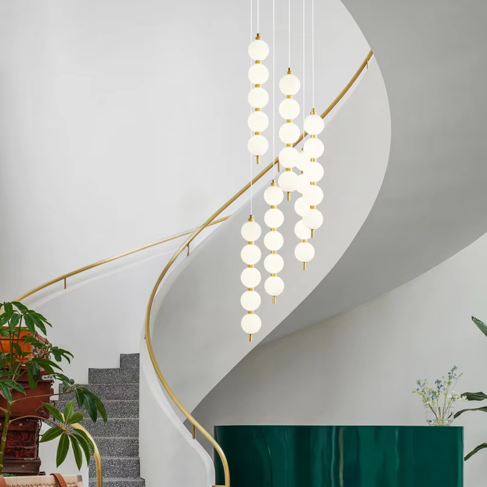 Modern light luxury double-strip spherical cascading chandelier, with a gold metal top plate paired with two strips of milky white luminous bulbs hanging staggered, emitting soft and even light, combining decorativeness and practicality, suitable for core lighting and atmosphere creation in spaces such as dining rooms, high-ceiling living rooms, and duplex stairs.