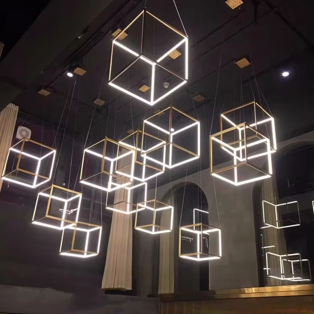 This light luxury minimalist cube chandelier features a gold metal frame with an embedded light-transmitting grid lampshade, using a floating suspension design, with a simple and exquisite shape, serving both lighting and decorative purposes, ideal for dining rooms, living rooms, modern light luxury homes and other scenarios.