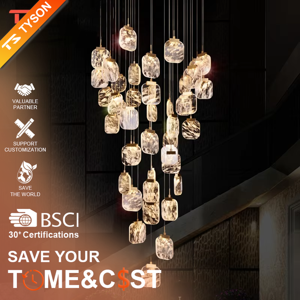This is a light luxury style duplex crystal chandelier, featuring a gold circular base paired with staggered and hanging marble-patterned crystal blocks. Light refracts through the crystals to create brilliant and luxurious lighting effects, serving both lighting and artistic decoration purposes, suitable for high-ceiling spaces such as villa high-ceiling living rooms, duplex voids, hotel lobbies, and spiral staircases.