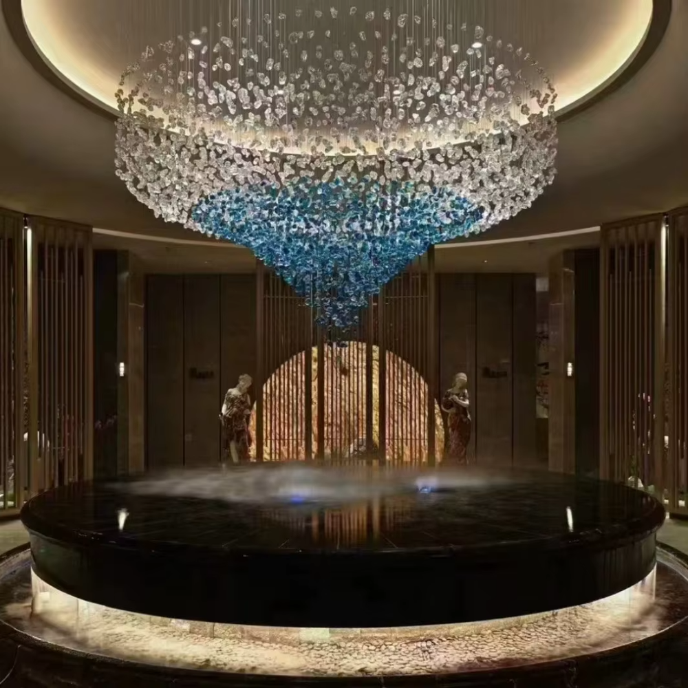 Luxury blue-white crystal column chandelier (gradient color crystals + hanging shape), warm light effect, creating a brilliant and elegant high-end space atmosphere.