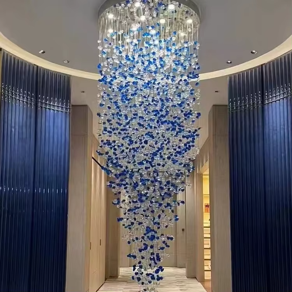 Luxury blue-white crystal column chandelier (gradient color crystals + hanging shape), warm light effect, creating a brilliant and elegant high-end space atmosphere.