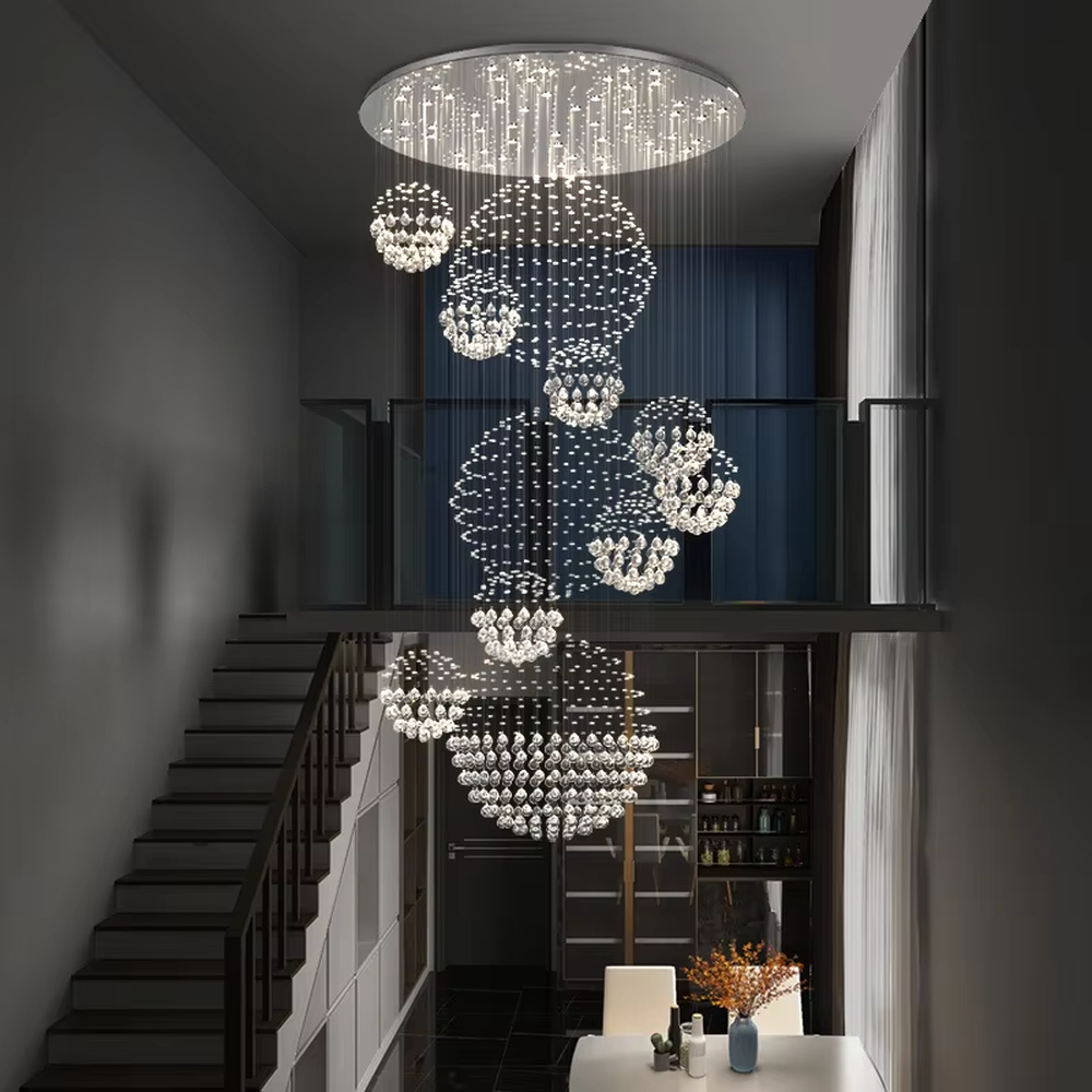 Modern luxury crystal ball cluster cascading chandelier, with a circular metal top plate paired with multiple groups of crystal-strung ball clusters hanging staggered, emitting brilliant and dreamy light, combining artistic decorativeness and lighting function, suitable for core decoration and main lighting in high-ceiling spaces such as duplex stairs, villa hollow areas, and high-end clubs.