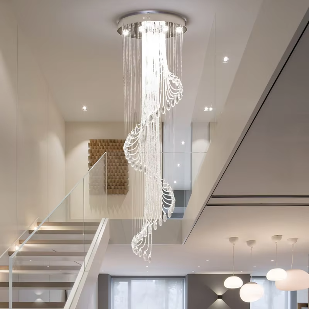This is a modern light luxury style artistic crystal chandelier, composed of multiple layers of transparent crystal strings and teardrop-shaped crystal pendants. Its streamlined shape resembles a flowing waterfall of light, serving both lighting and artistic decoration purposes, suitable for high-ceiling spaces such as villa high-ceiling living rooms, duplex voids, hotel lobbies, and high-end clubs.