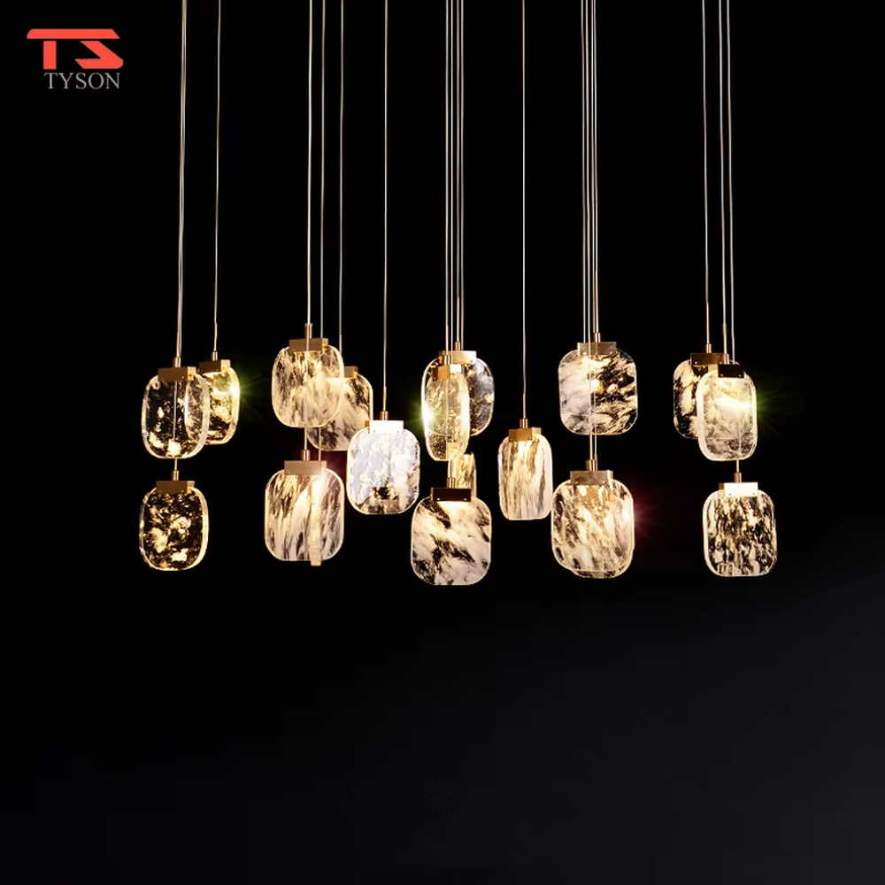 This is a light luxury style duplex crystal chandelier, featuring a gold circular base paired with staggered and hanging marble-patterned crystal blocks. Light refracts through the crystals to create brilliant and luxurious lighting effects, serving both lighting and artistic decoration purposes, suitable for high-ceiling spaces such as villa high-ceiling living rooms, duplex voids, hotel lobbies, and spiral staircases.