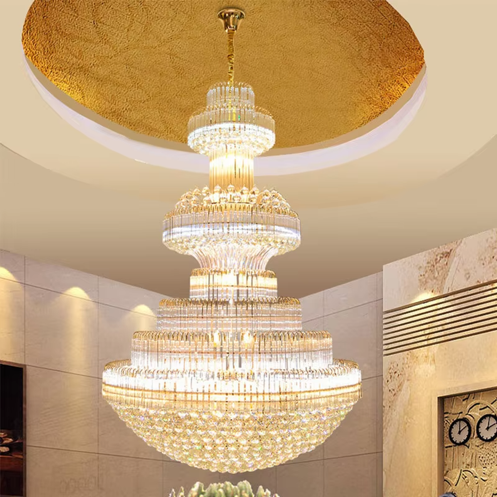 This is a luxurious pagoda-style multi-layered round crystal chandelier, featuring a gold metal frame paired with dense crystal strips in a tiered circular structure. It emits brilliant and gorgeous light, serving both lighting and decorative purposes, suitable for large luxurious spaces such as hotel lobbies, villa high-ceiling living rooms, banquet halls, and high-end clubs.