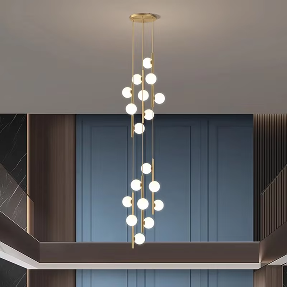 Nordic light luxury style staggered spherical chandelier, with gold metal suspension rods paired with milky white luminous bulbs, arranged in a cascading staggered layout. It emits soft and warm light, combining decorativeness and lighting function, suitable for core lighting and atmosphere creation in high-ceiling spaces such as duplex stairs, high-ceiling living rooms, and villa hollow areas.
