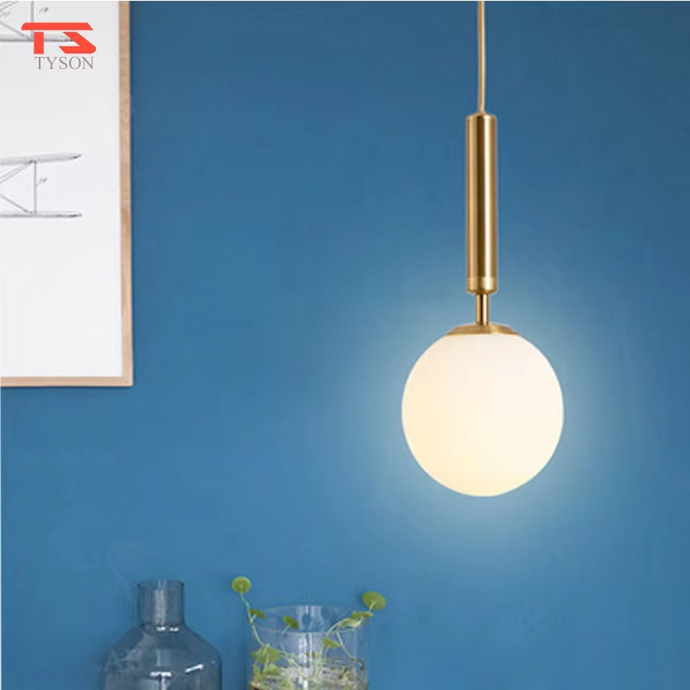 Minimalist gold rod glass ball chandelier (gold cylinder hanging rod + milk-white glass ball), warm light effect, creating a simple and high-end space atmosphere.