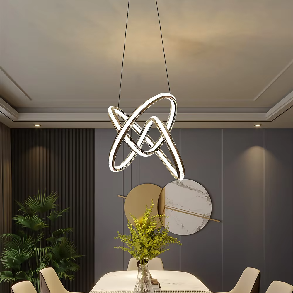 This is a modern artistic golden crossed ring chandelier, with a golden metal crossed ring structure and embedded crystal elements, featuring a minimalist and grand design, brilliant lighting. It is used for space lighting and decoration, creating a modern luxurious atmosphere. Suitable for modern minimalist living rooms, high-end creative restaurants, designer studios and other places.