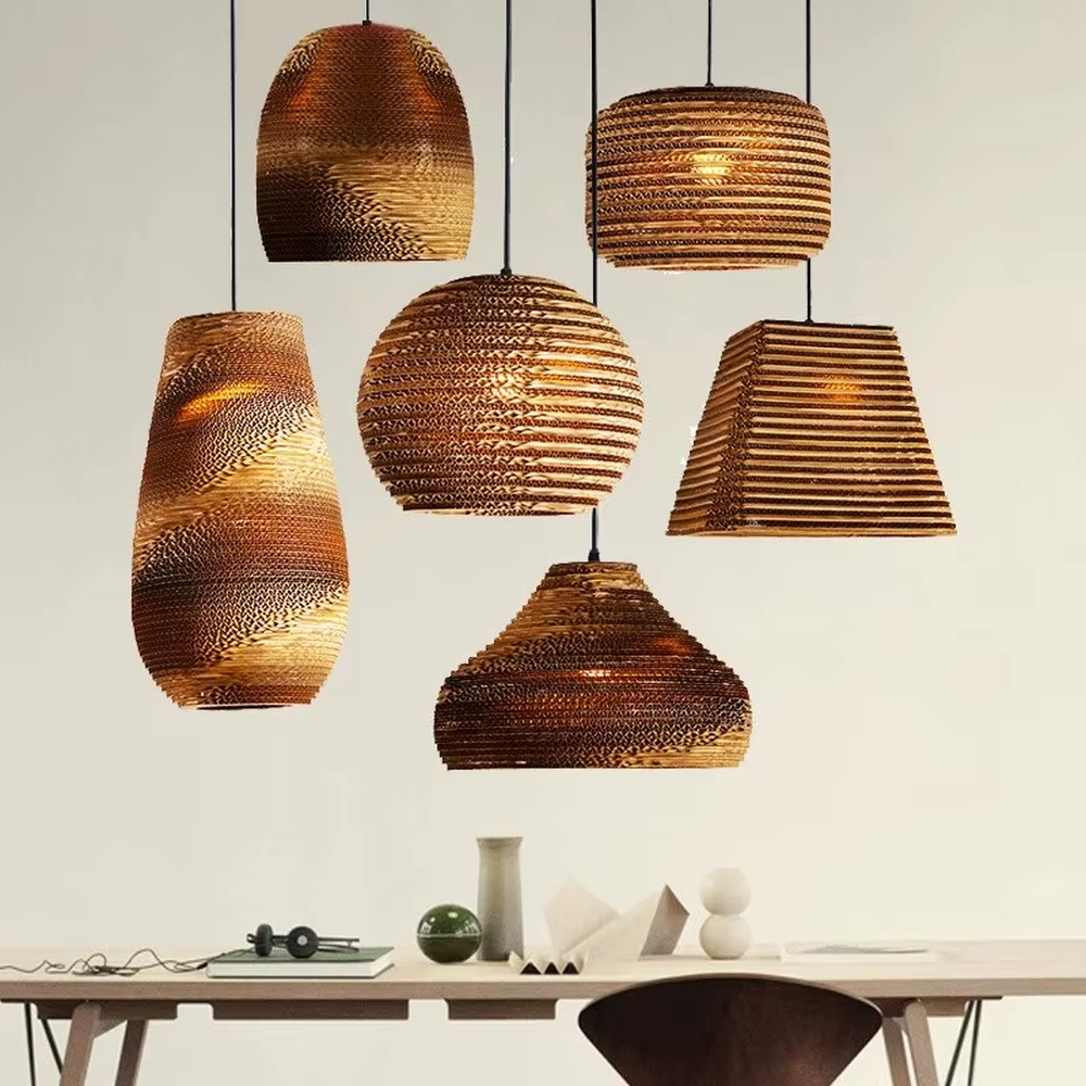 This is a set of natural artistic paper chandeliers, featuring various geometric shapes made of corrugated paper with brown textures, simple and natural, and artistic in design. It is used for space lighting and decoration, creating a natural and artistic atmosphere. It is suitable for Nordic-style home dining rooms, creative cafes, art studios and other places.