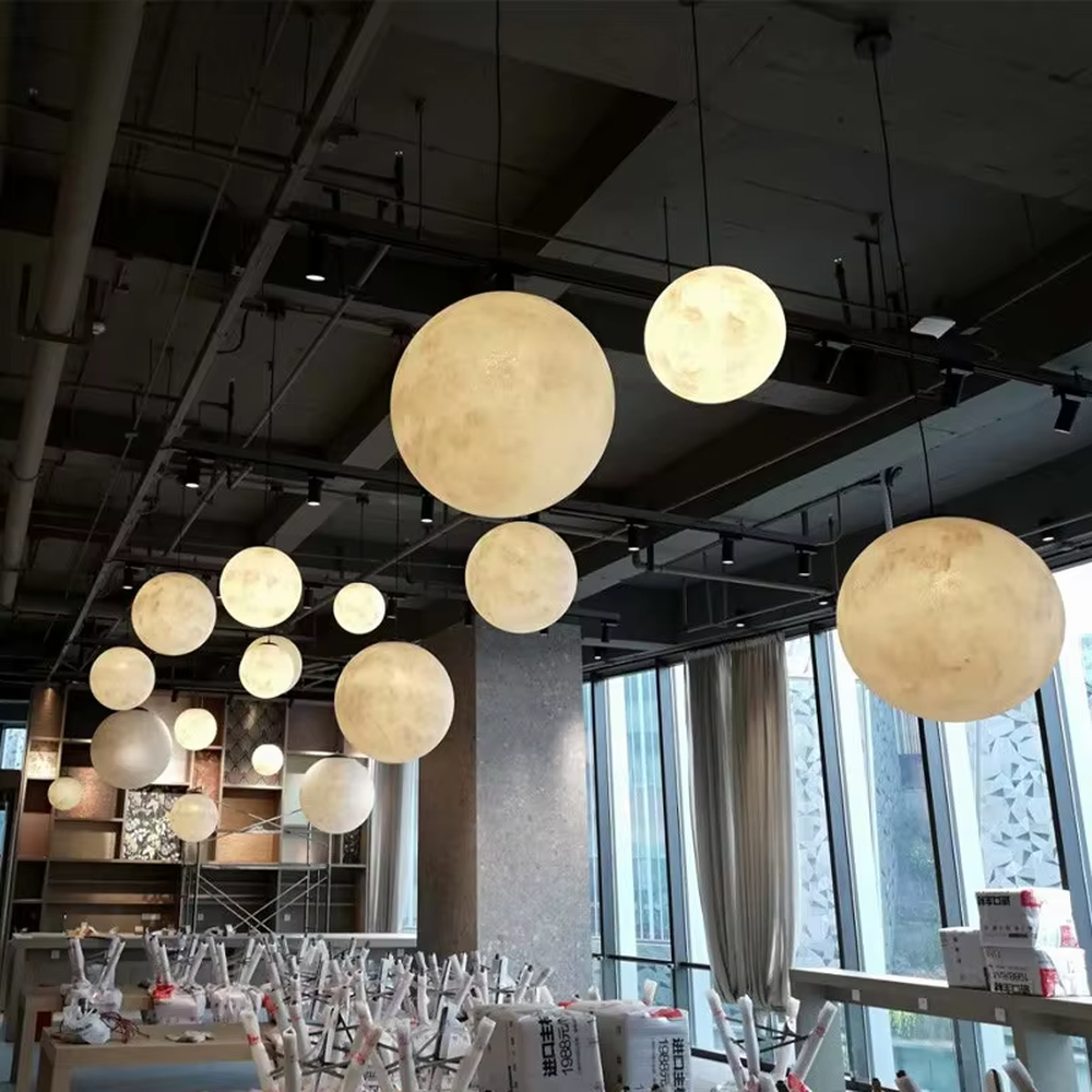 This moon-shaped chandelier simulates lunar surface texture with soft light-transmitting material, hung in varying sizes, serving both lighting and decorative purposes, ideal for Internet celebrity restaurants, cafes, office spaces, exhibition halls and other scenarios.