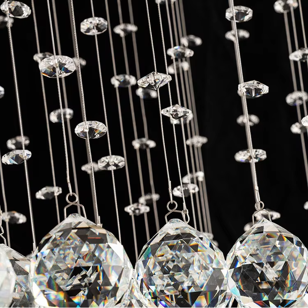 This is a luxury square crystal ceiling light, with a square metal frame and multi-layer transparent crystal pendants, brilliant lighting, featuring a magnificent and grand design with strong visual impact. It is used for space lighting and decoration, creating a high-end luxury atmosphere. It is suitable for high-ceilinged living rooms, luxury villas, high-end hotel lobbies and other places.