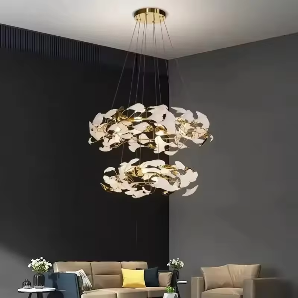 This is a new Chinese luxury ginkgo leaf multi-layer chandelier, with a golden metal frame and white ginkgo leaf design, featuring natural art and luxury texture. It is used for space lighting and decoration, creating a natural luxury ambiance. It is suitable for high-end residential double-height living rooms, luxury hotel lobbies, art clubs and other places.