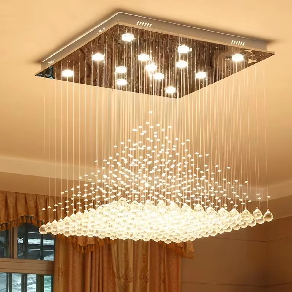 This is a luxury square crystal ceiling light, with a square metal frame and multi-layer transparent crystal pendants, brilliant lighting, featuring a magnificent and grand design with strong visual impact. It is used for space lighting and decoration, creating a high-end luxury atmosphere. It is suitable for high-ceilinged living rooms, luxury villas, high-end hotel lobbies and other places.