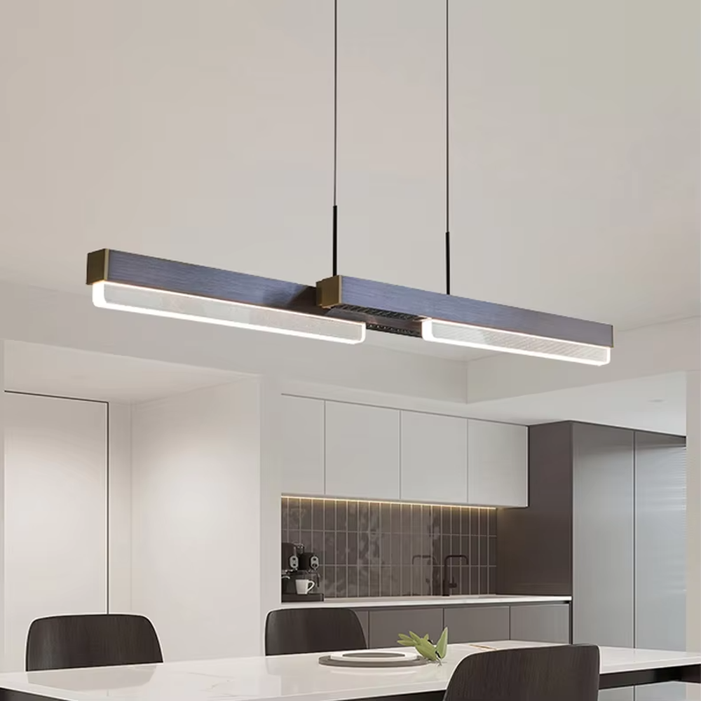 This is a modern minimalist style linear chandelier, featuring a walnut texture panel paired with brass metal accents. The linear lighting design emits soft and uniform light, serving both practical lighting and space decoration purposes, suitable for dining rooms, open kitchens, light luxury bars, modern office areas and other scenarios.