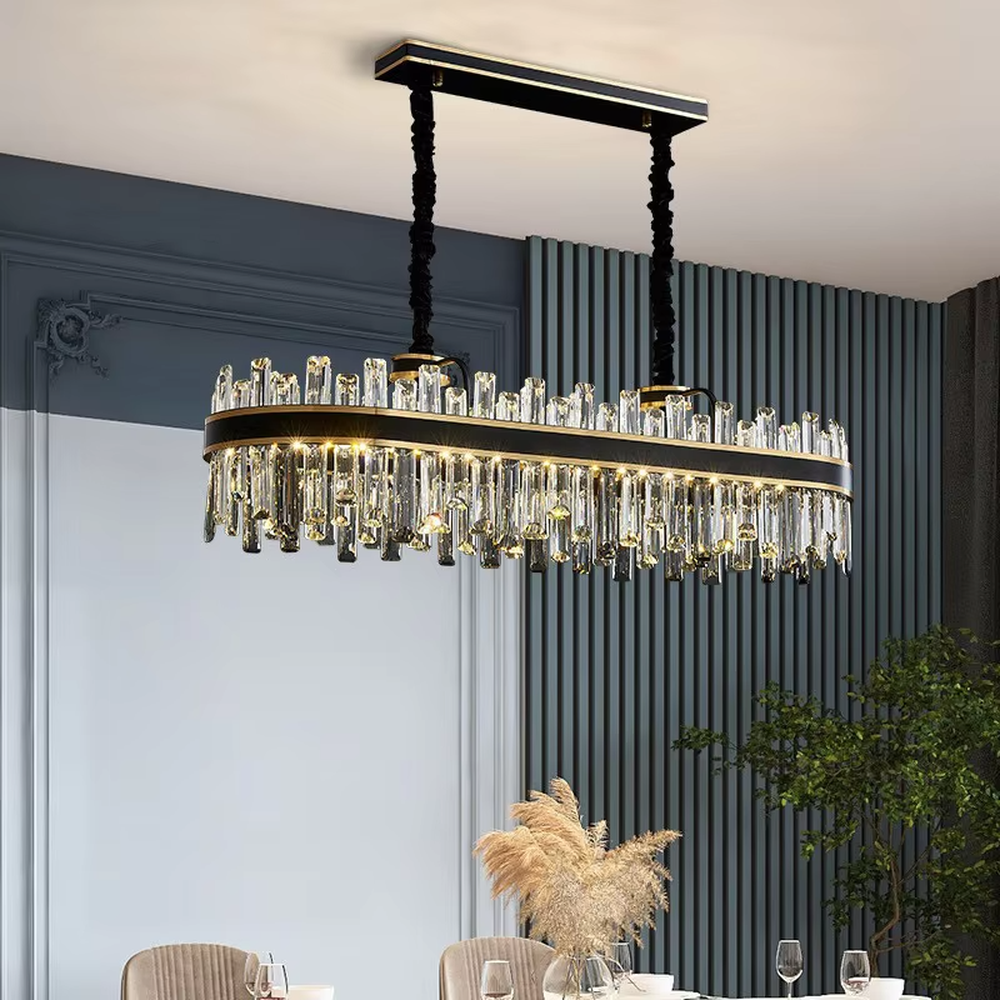 This is a light luxury modern-style black and gold rectangular crystal chandelier, with a black and gold metal frame, paired with numerous transparent crystal columns and black woven hanging ropes. It features a light luxury and grand design, with brilliant lighting. It is used for space lighting and decoration, creating a light luxury and high-end atmosphere. Suitable for light luxury-style restaurants, modern minimalist living rooms, high-end hotel dining areas and other places.